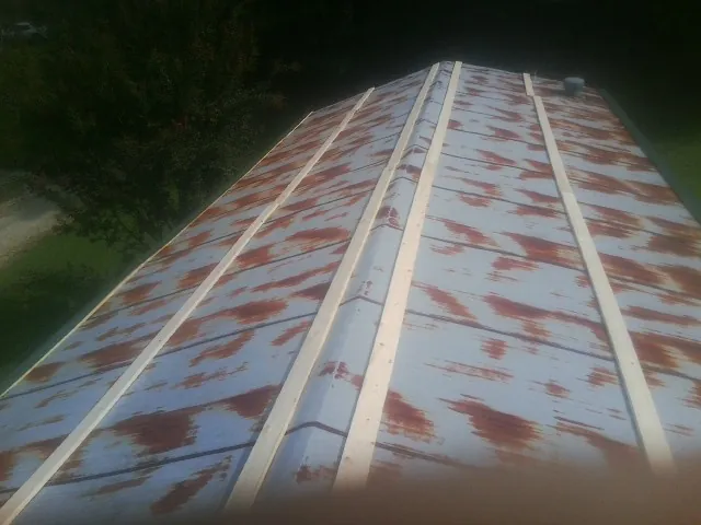Rusted metal roof panels with new wood purlins before replacement — Storm Damage Roof Repair in Smicksburg by Roofing Brothers